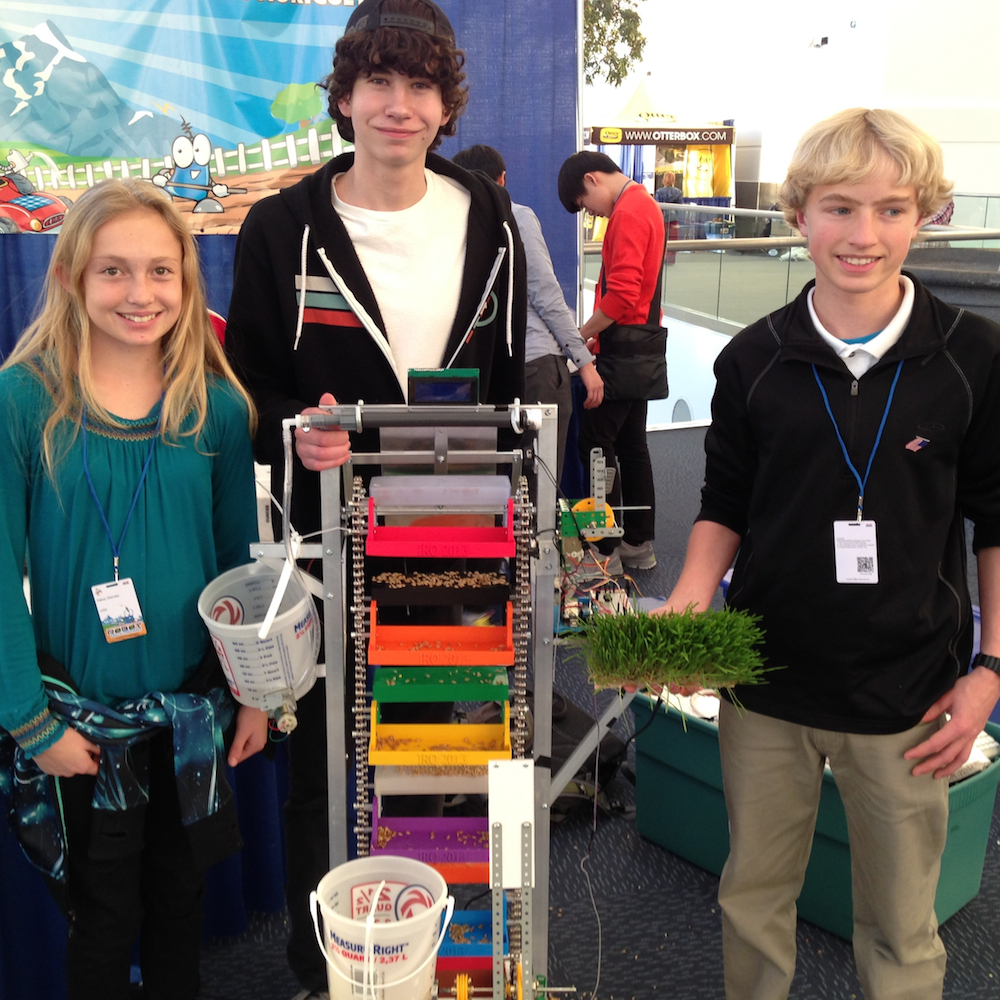 Haley Steinke, Ryan Ham, and Samuel Zimmer, of the Denver area, with their seed sprouting robot.