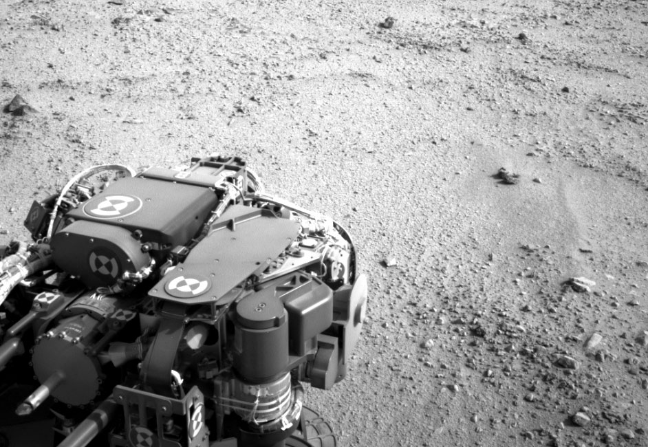 Curiosity Heading for Mount Sharp, during the 329th Martian day, or sol, of the rover’s work on Mars (July 9, 2013).  The turret of tools at the end of Curiosity’s robotic arm is in the foreground, with the rover’s rock-sampling drill in the lower left corner of the image. Image credit: NASA/JPL-Caltech.