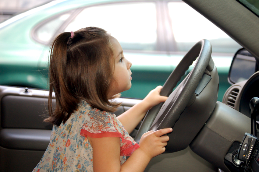 Little kids driving store cars