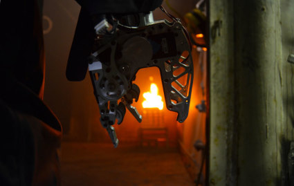 Firefighting robot: SAFFiR’s hands are strong enough to grip and hold a firehouse blasting water. When operating the firehouse in wet conditions, the robot wore custom designed "gloves" to protect it from water damage. Source: Virginia Tech.