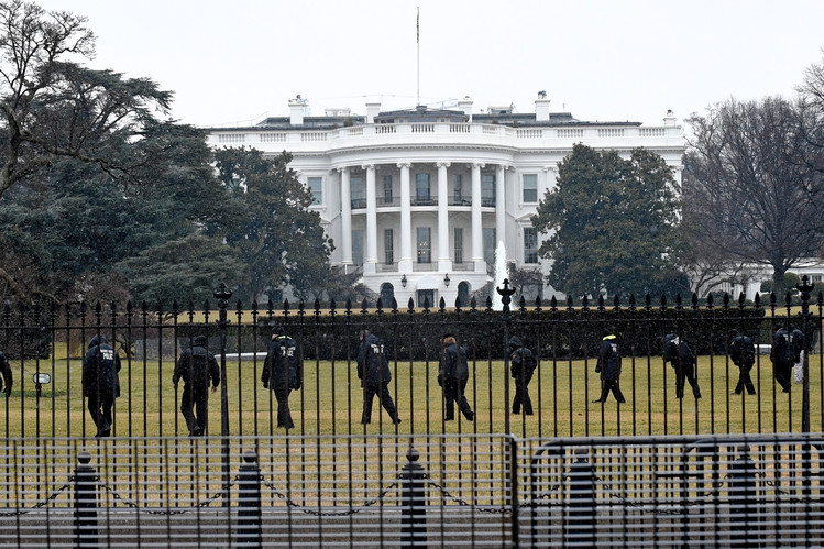 Secret Service officers search White House grounds after a hobbyist drone crashed on the lawn. Credit: Associated Press