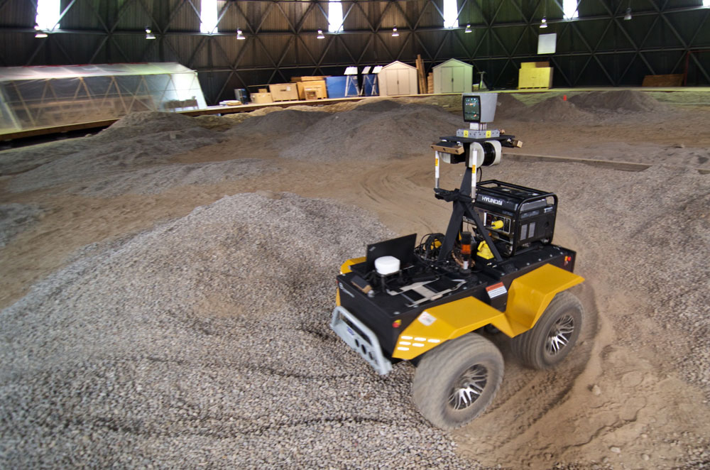 June 26, 2015 -  Grizzly RUV negotiating a sharp turn on a bumpy terrain composed of sand and gravel. The Grizzly RUV is built by Clearpath Robotics and weighs around 1000 kg. Autonomous driving capabilities were demonstrated over a long distance using only one stereo camera in a GPS denied environment. Photo credit: François Pomerleau - University of Toronto.