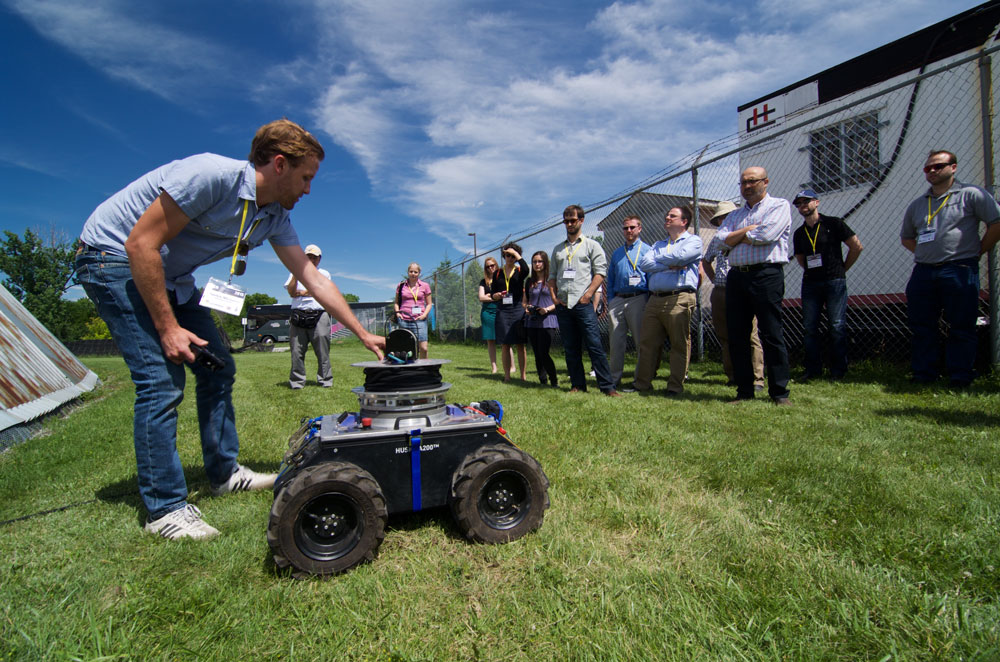 June 26, 2015 - The Tethered Robotic Explorer (TReX) robot being described by Patrick McGarey to a visiting group. The newly conceived platform was unveil to the public for the first time. TReX can climb many kind of steep terrain with the help of its onboard tether management system. It weighs roughly 90 kg and was built over a Husky from Clearpath Robotics. Photo credit: François Pomerleau - University of Toronto