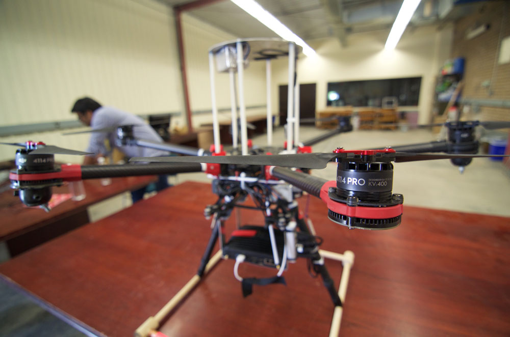June 26, 2015 - The Waterloo Autonomous Vehicles Laboratory hexrotor drone, affectionately named Olga, sports three high-speed wide field-of-view cameras, which it uses to determine its own motion in unknown environments. Olga recently flew in Kelowna, BC at the NCFRN Field Trials, where it used the multi-camera cluster to construct maps of cliff faces and hiking trails, similar to those needed in mining and agriculture inspection applications. Photo credit: François Pomerleau - University of Toronto.