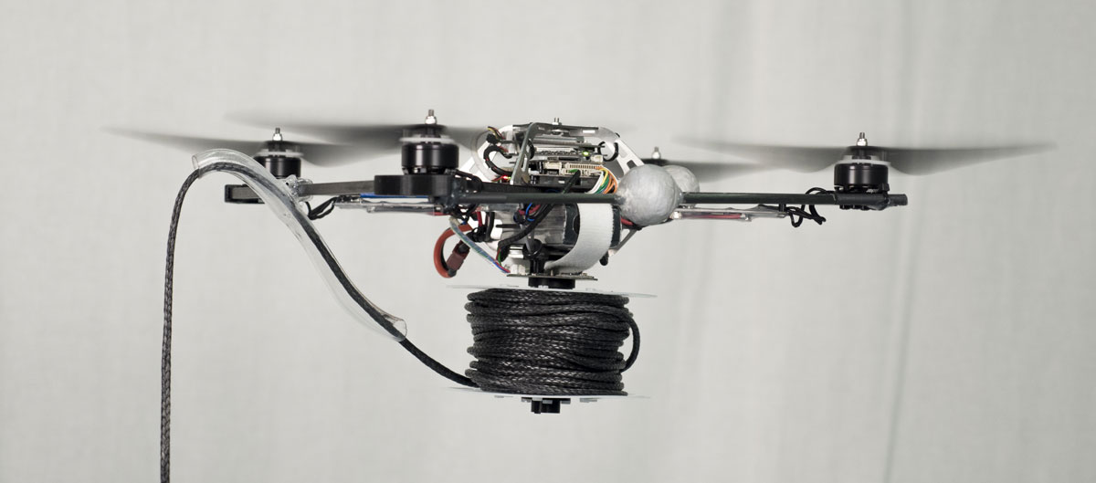 A quadrocopter equipped with a motorized spool for rope deployment.  