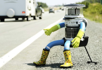 The anthropomorphic robot named hitchBOT sits on the shoulder of Highway 102 to begin its 6000 kilometer cross country journey outside of Halifax, Nova Scotia, July 27, 2014. The hitch hiking robot is part of a social experiment to see if drivers will pick up and drop off the robot in one piece to an art gallery in Victoria, British Columbia.  REUTERS/Paul Darrow (CANADA - Tags: SOCIETY SCIENCE TECHNOLOGY TPX IMAGES OF THE DAY)