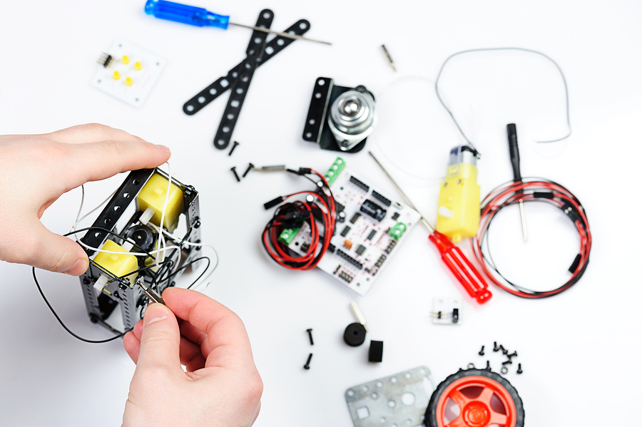 assemble robot body with screw on white isolated