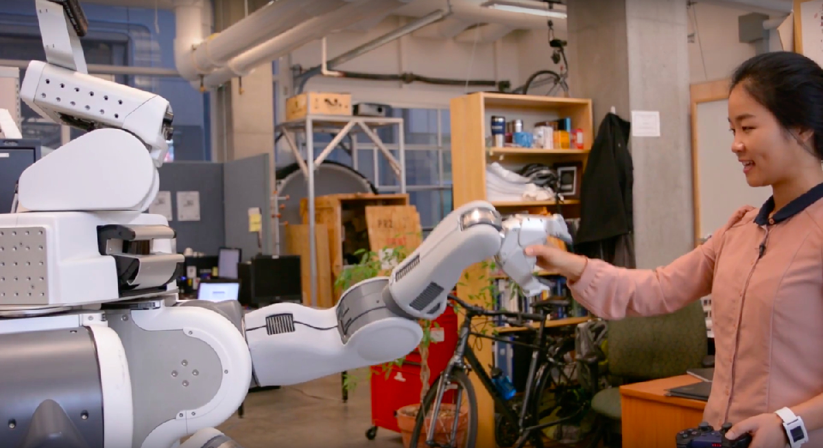 Researcher with robot. Photo source: ubcpublicaffairs/YouTube