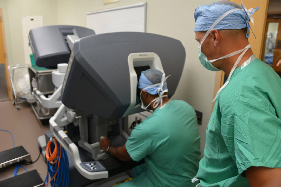 Maj. (Dr.) George Kallingal showcases a robotic surgical system while Lt. Col. (Dr.) Thomas Novak, Brooke Army Medical Center's chief of pediatric urology, looks on at San Antonio Military Medical Center in San Antonio.  Photo credit: Robert Shields