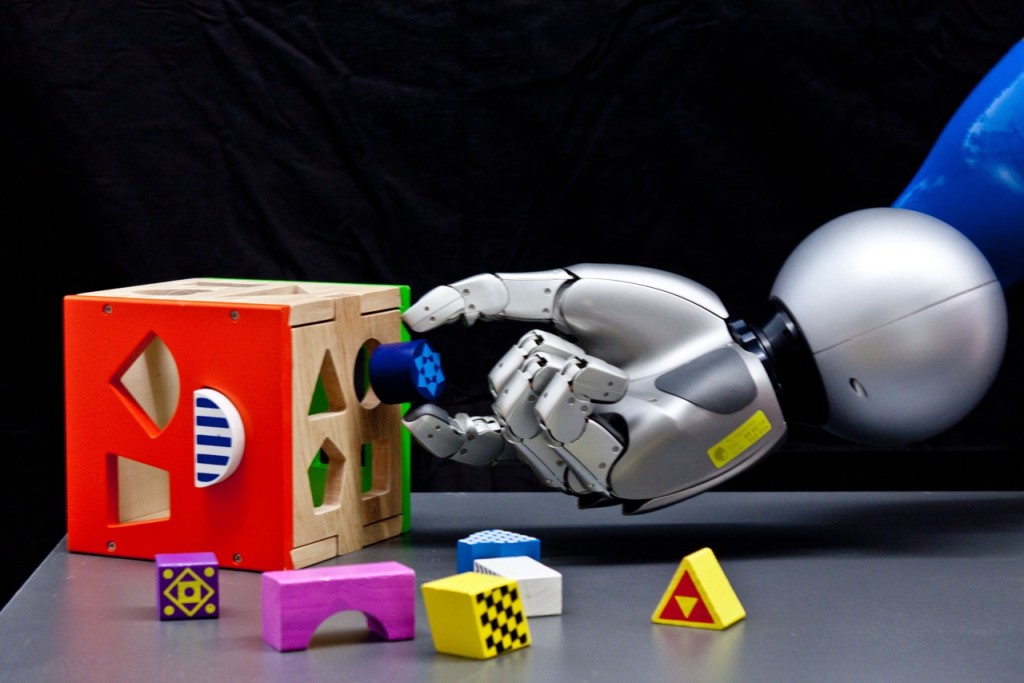 Robotic hand tries to put object in the holes of a toy. Credits: Technische Universitaet Darmstadt