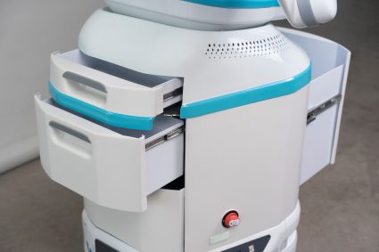 A close-up of the body of a robot with two small storage containers open in the front and one large storage container open in the back. 